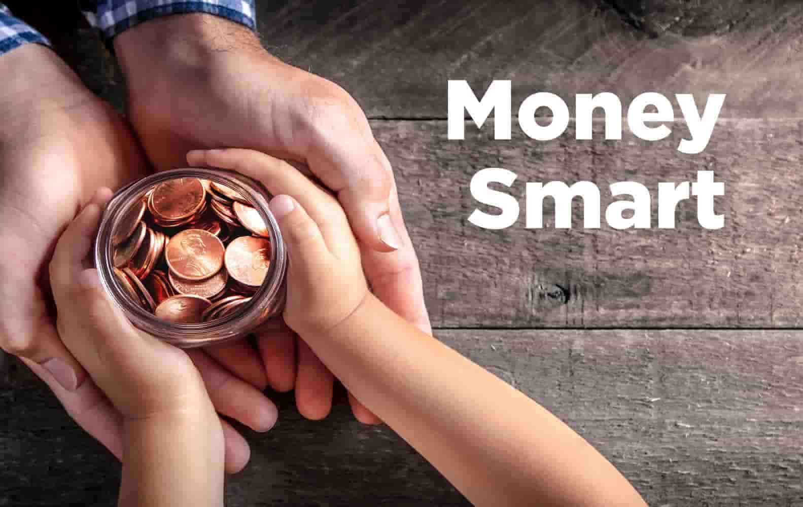 An adult's hands and a child's hands hold a small glass jar of pennies. Text reads "Money Smart" 